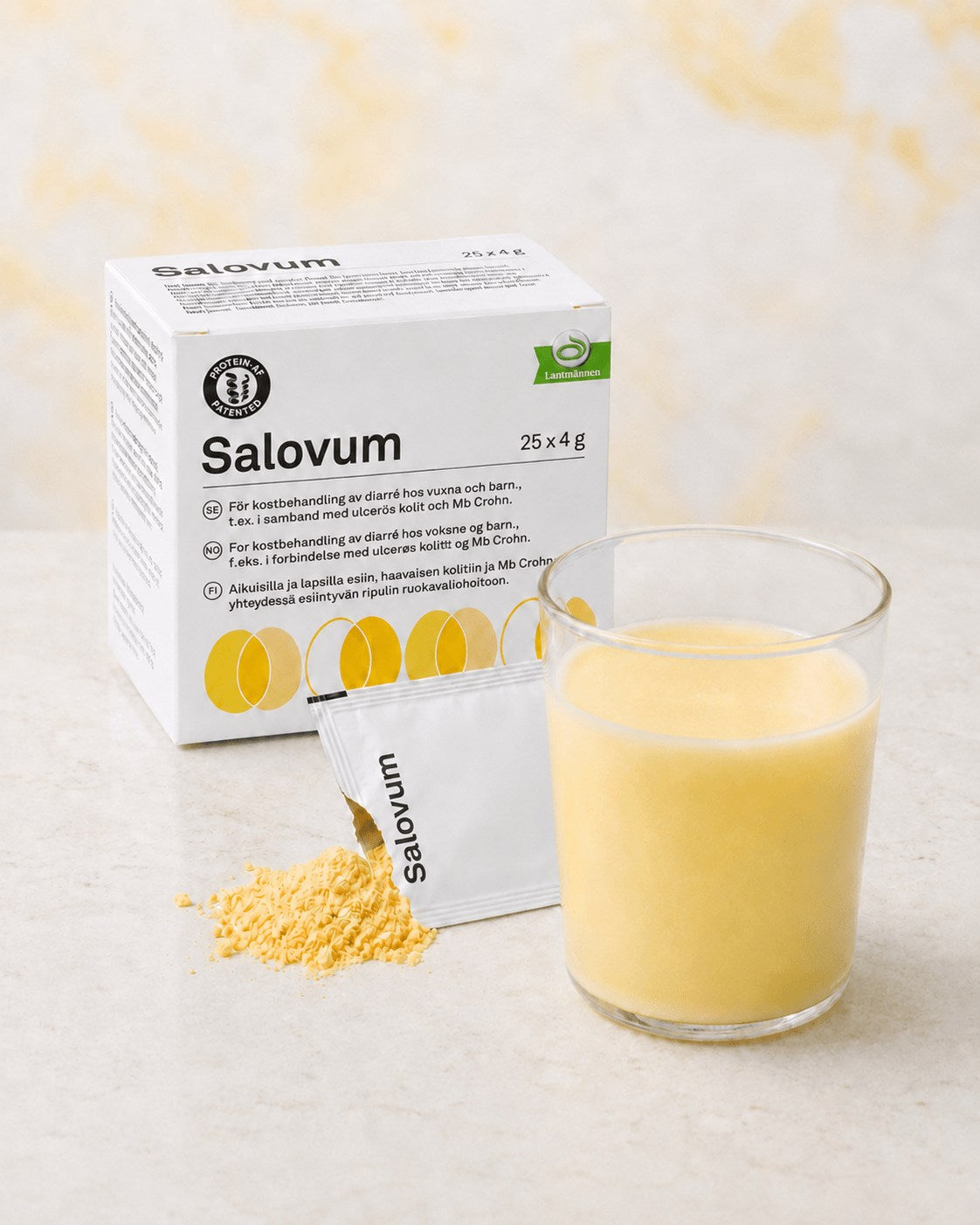 Salovum box, an opened sachet with yellow powder and a glass of mixed Salovum